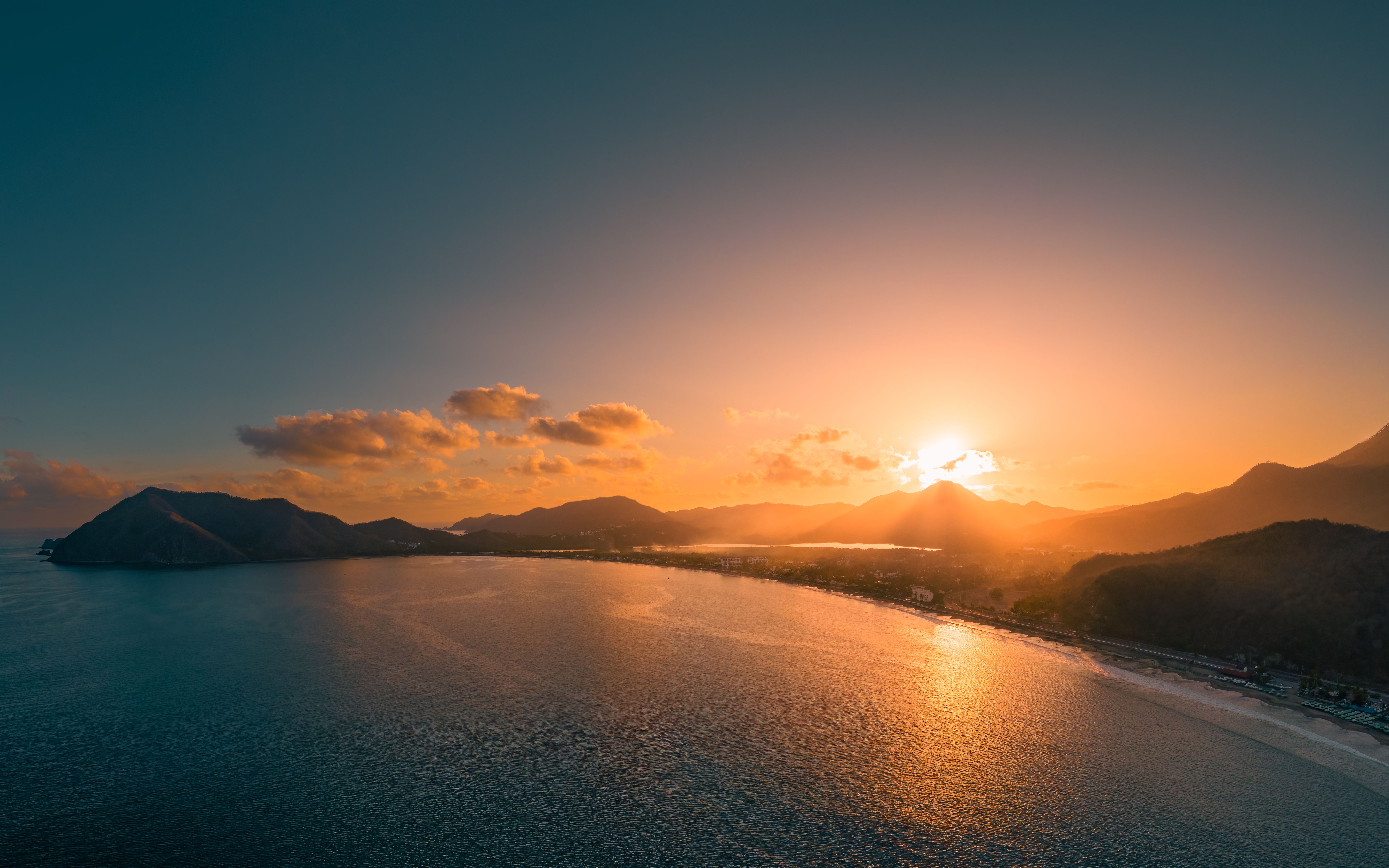 Drone shot of the sunrise scene over the Miramar beach in Manzanillo city in Colima, Mexico